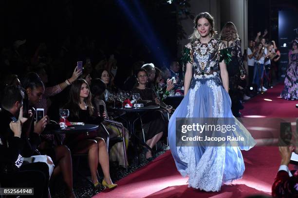 Model walks the runway at the Dolce & Gabbana secret show during Milan Fashion Week Spring/Summer 2018 at Bar Martini on September 23, 2017 in Milan,...