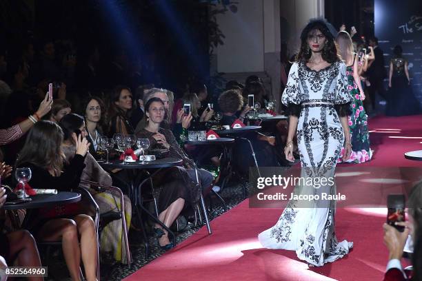 Model walks the runway at the Dolce & Gabbana secret show during Milan Fashion Week Spring/Summer 2018 at Bar Martini on September 23, 2017 in Milan,...