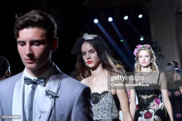 Models walk the runway at the Dolce & Gabbana secret show during Milan Fashion Week Spring/Summer 2018 at Bar Martini on September 23, 2017 in Milan,...