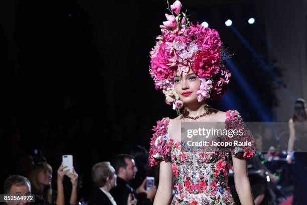 Model walks the runway at the Dolce & Gabbana secret show during Milan Fashion Week Spring/Summer 2018 at Bar Martini on September 23, 2017 in Milan,...