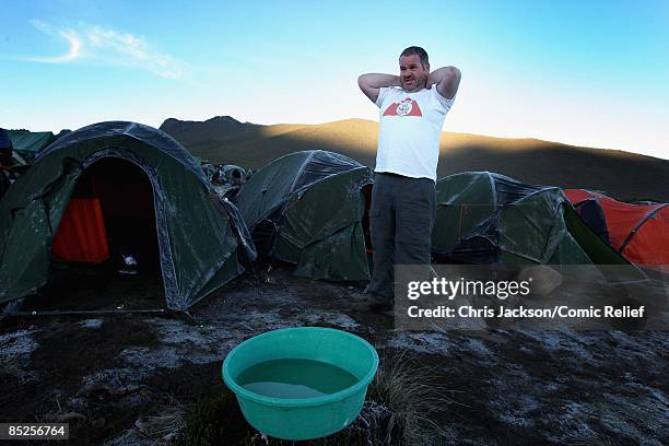 Chris Moyles washes on the second day of The BT Red Nose Climb of Kilimanjaro on March 1, 2009 in Arusha, Tanzania. Celebrities Ronan Keating, Gary...