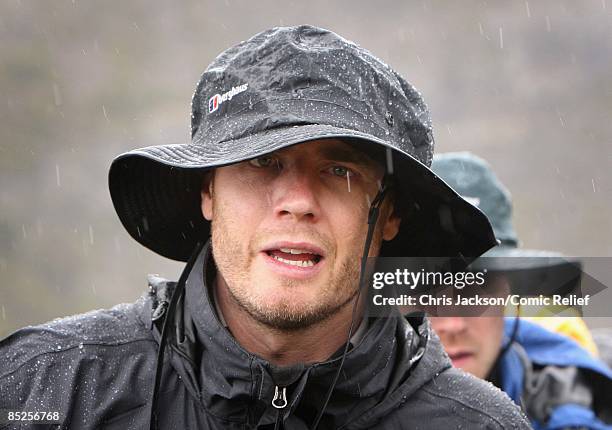 Gary Barlow treks into camp in the rain on the fifth day of The BT Red Nose Climb of Kilimanjaro on March 5, 2009 near Arusha, Tanzania. Celebrities...