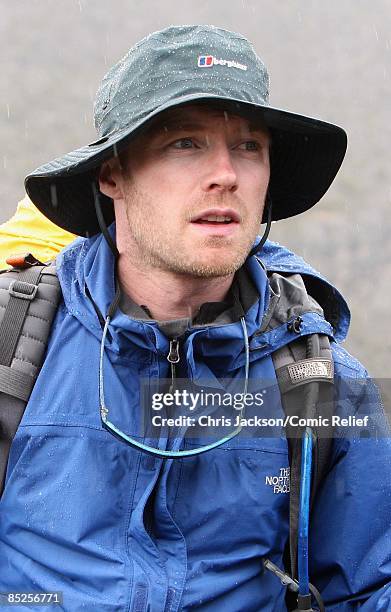 Ronan Keating treks into camp in the rain on the fifth day of The BT Red Nose Climb of Kilimanjaro on March 5, 2009 near Arusha, Tanzania....