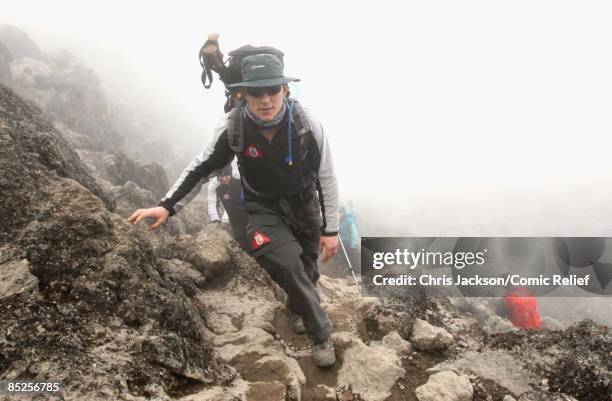 Ben Shephard treks into camp in the rain on the fifth day of The BT Red Nose Climb of Kilimanjaro on March 5, 2009 in Arusha, Tanzania. Celebrities...