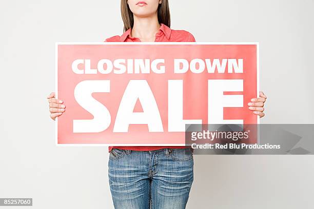 woman holding a closing down sign - carrying sign stock-fotos und bilder