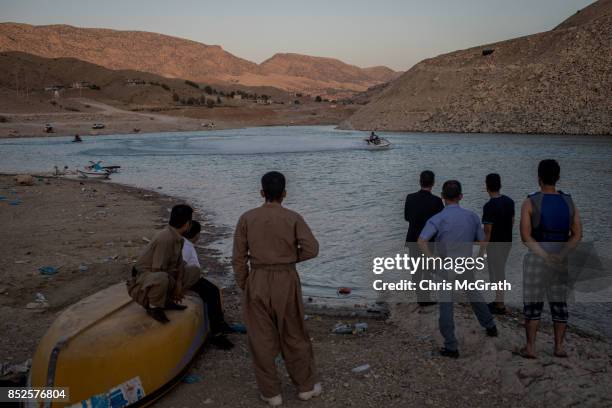 People enjoy the waters edge at lake Dukan ahead of the upcoming referendum for independence of Kurdistan on September 23, 2017 in Sulaymaniyah,...