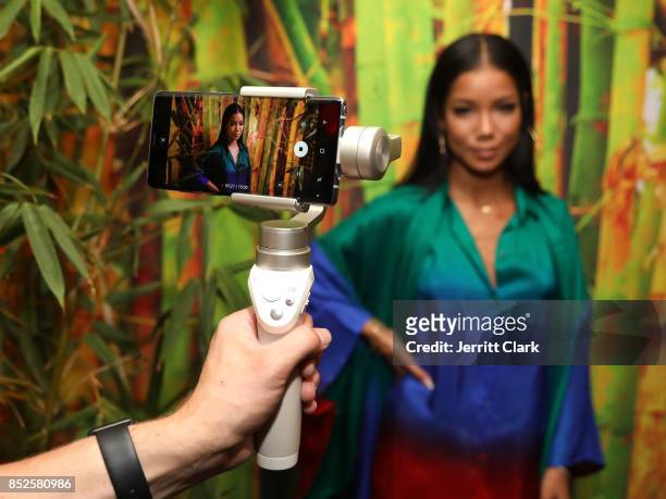 Jhene Aiko poses for a video on a Samsung Galaxy Note 8 during her a TRIP launch party powered by Samsung at EB Gallery on September 22, 2017 in Los...