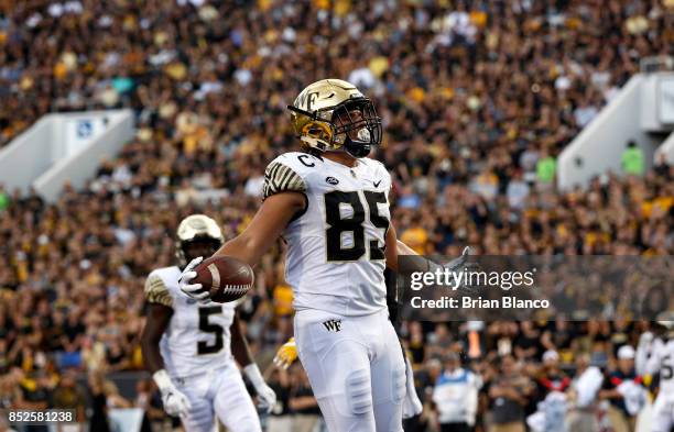 Tight end Cam Serigne of the Wake Forest Demon Deacons celebrates in the end zone after hauling in a pass for a touchdown during the third quarter of...
