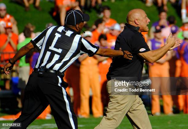 Head coach Steve Addazio of the Boston College Eagles is pulled back to the sideline by an official during their game against the Clemson Tigers at...