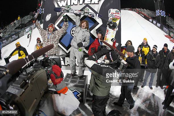 Gold medal winner Shaun White,center, joins silver medalist Mason Aguirre, left, and bronze medalist Scotty Lago on the podium in the Winter X Games...