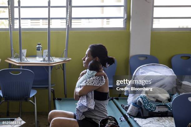 Resident holds her baby inside a shelter after being evacuated from a home near the damaged Guajataca Dam after Hurricane Maria in Isabela, Puerto...