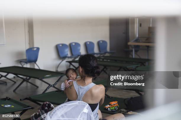 Resident holds her baby inside a shelter after being evacuated from a home near the damaged Guajataca Dam after Hurricane Maria in Isabela, Puerto...