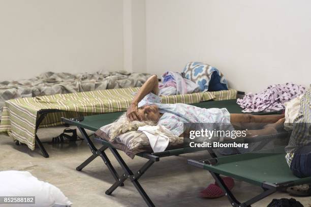 Resident lay on a cot inside a shelter after being evacuated from a home near the damaged Guajataca Dam after Hurricane Maria in Isabella, Puerto...