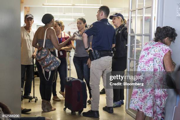 Resident wait inside a shelter after being evacuated from a home near the damaged Guajataca Dam after Hurricane Maria in Isabella, Puerto Rico, on...