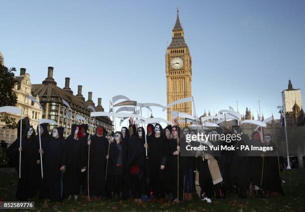 Amnesty supporters dressed as grim reapers gather in Parliament Square, central London, to protest UK government's endorsement of Sri Lanka at the...