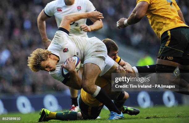 England's Billy Twelvetrees is tackled during the QBE International at Twickenham, London.