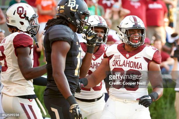 Dimitri Flowers of the Oklahoma Sooners celebrates after scoring on a 52-yard touchdown reception against the Baylor Bears during the first half at...