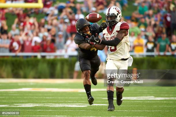 CeeDee Lamb of the Oklahoma Sooners makes a catch against Grayland Arnold of the Baylor Bears during the first half at McLane Stadium on September...