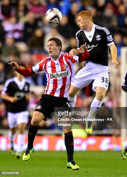 Sunderland's Craig Gardner and Southampton's Harrison Reed jump for the ball during the Capital One Cup match at the Stadium of Light, Sunderland.
