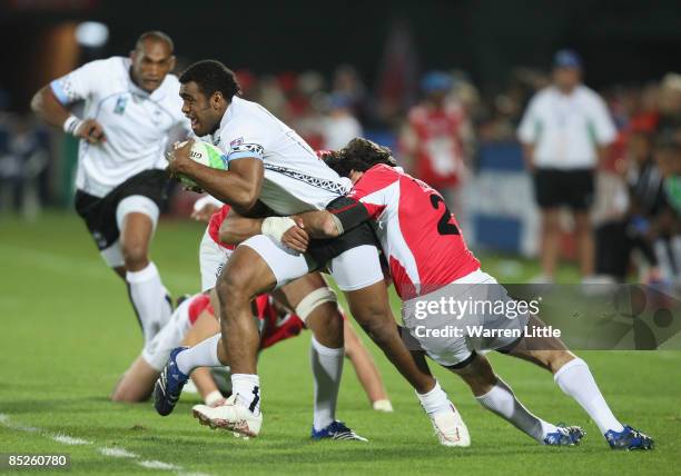 Napolinoi Nalaga of Fiji is tackled by Alexander Todua of Georgia during their Pool B IRB Rugby World Cup Sevens 2009 at The Sevens stadium on March...