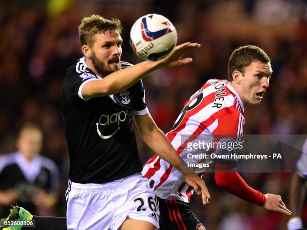 Sunderland's Craig Gardner and Southampton's Jos Hooiveld during the Capital One Cup match at the Stadium of Light, Sunderland.
