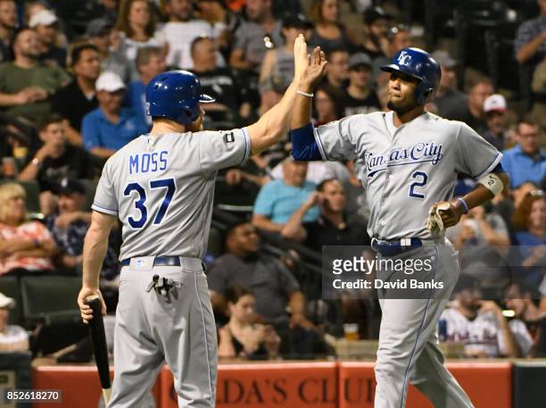 Brandon Moss of the Kansas City Royals greets Alcides Escobar after scoring against the Chicago White Sox during the seventh inning on September 23,...