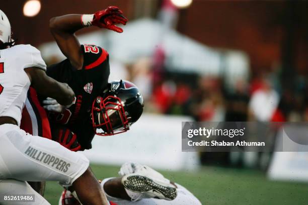 Wide Receiver Justin Hall of the Ball State Cardinals is tackled by Western Kentucky Player on September 23, 2017 in Bowling Green, Kentucky.