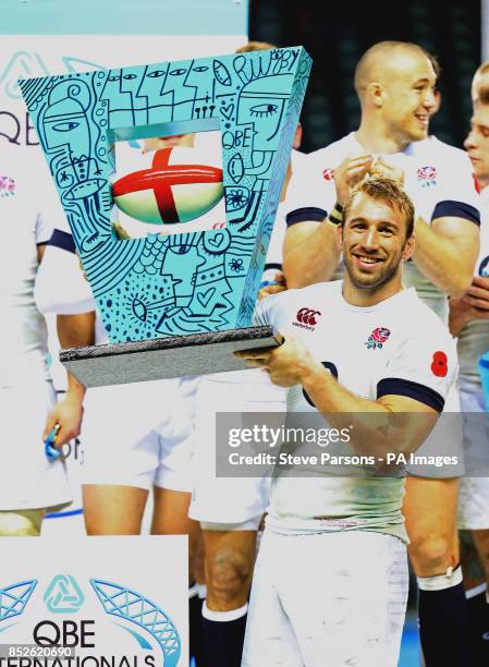 England's Chris Robshaw lifts the trophy after beating Argentina in the QBE International at Twickenham, London.