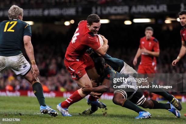 Wales' George North is held short of a try during the Dove Men Series match at the Millennium Stadium, Cardiff.