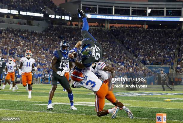 Conrad of the Kentucky Wildcats leaps over Marco Wilson of the Florida Gators during the game at Kroger Field on September 23, 2017 in Lexington,...