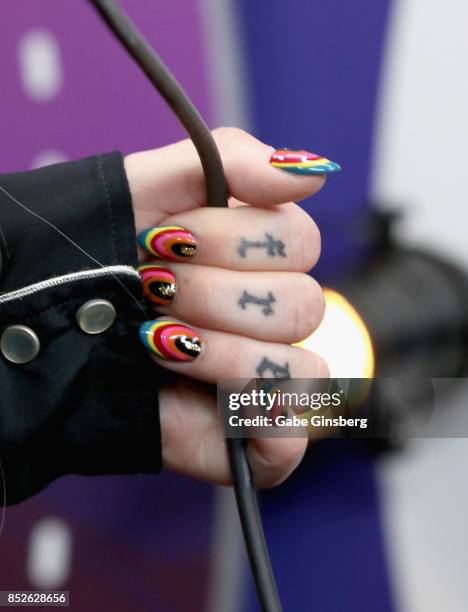 Kesha, tattoo, fashion, and manicure details, attends the 2017 iHeartRadio Music Festival at T-Mobile Arena on September 23, 2017 in Las Vegas,...