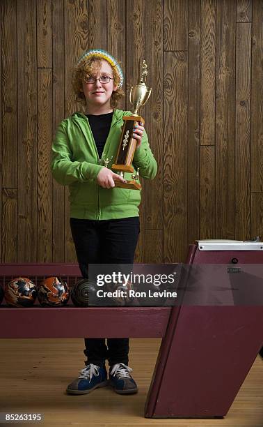 young girl with trophy at bowling alley - bowlingbahn stock-fotos und bilder