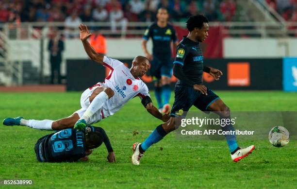 Wydad Athletic Club's Achraf Bencharki vies for the ball with Mamelodi Sundowns's Samuel Tiyani Mabunda during the CAF Champions League...