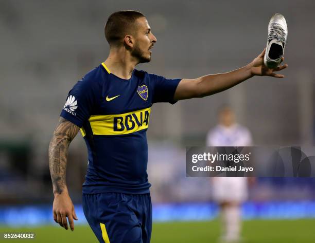 Dario Benedetto of Boca Juniors holds up one of his shoes during a match between Velez Sarsfield and Boca Juniors as part of the Superliga 2017/18 at...