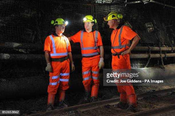 Chancellor George Osborne talks to chief executive of UK Coal Kevin McCullough and communications director Andrew McKintosh down the mineshaft during...