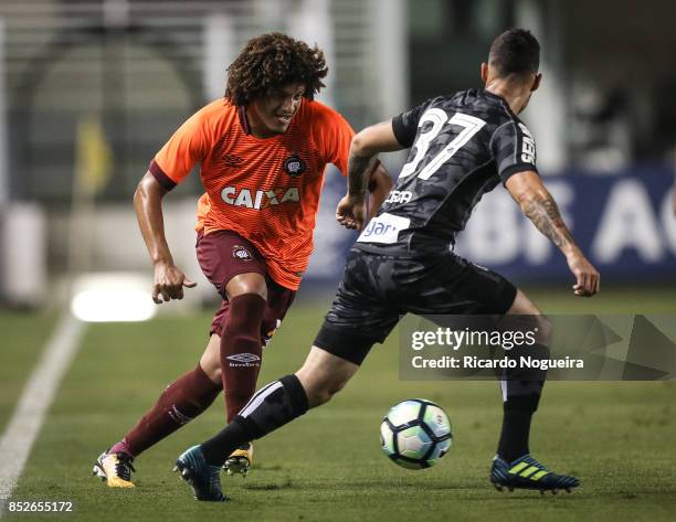 Zeca of Santos battles for the ball with Felipe Gedoz of Atletico Paranaense during the match between Santos and Atletico Paranaense as a part of...