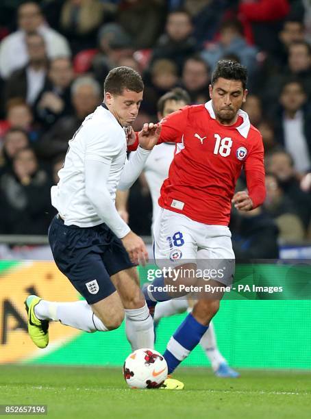Chile's Gonzalo Jara and England's Ross Barkley battle for the ball