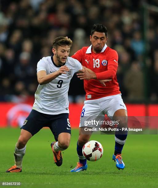 Chile's Gonzalo Jara and England's Adam Lallana battle for the ball