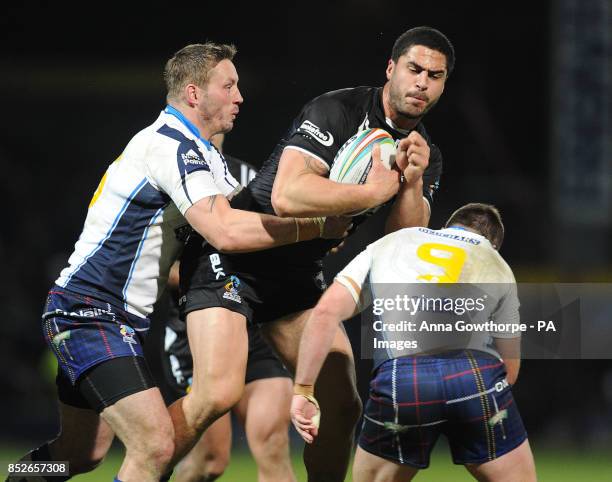 New Zealand's Jesse Bromwich is tackled by Scotland's Oliver Wilkes and Ian Henderson during the World Cup Quarter Final match at Headingley Stadium,...