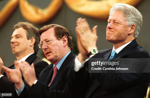 President Bill Clinton joins British Prime Minister Tony Blair, left, and Northern Ireland's First Minister David Trimble at the Storemont Parliament...