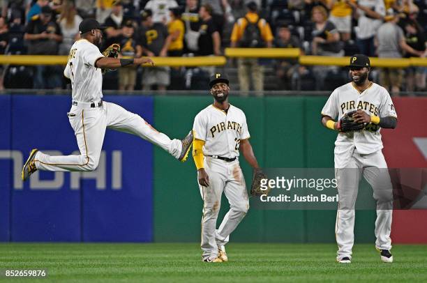 Starling Marte of the Pittsburgh Pirates celebrates with Andrew McCutchen and Gregory Polanco after the final out in the Pittsburgh Pirates 11-6 win...