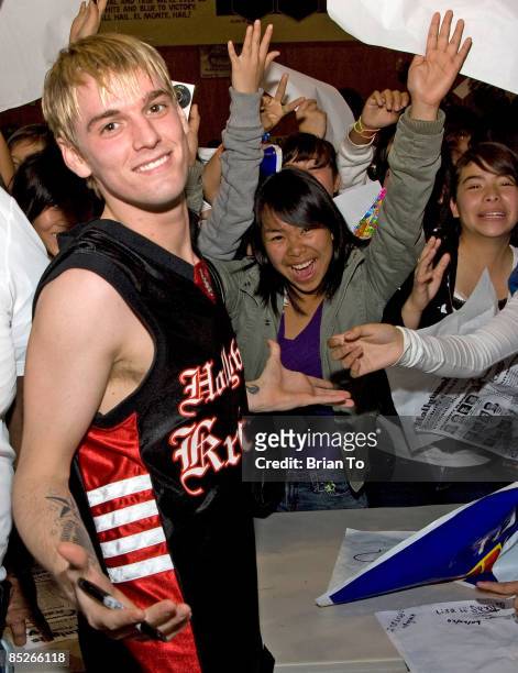 Pop singer Aaron Carter poses with fans at The Hollywood Knights Celebrity Basketball Game at El Monte High School on March 4, 2009 in El Monte,...