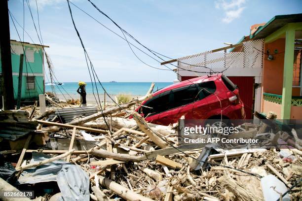 Car sits amid destruction on September 22, 2017 in Roseau on the Caribbean island of Dominica, following passage of Hurricane Maria. Hurricane Maria...