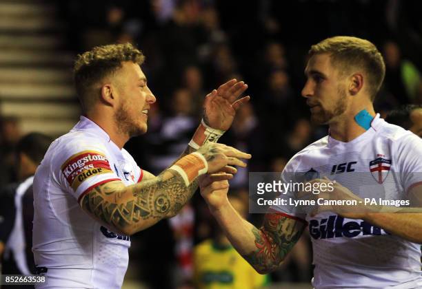 England's Joshua Charnley celebrates scoring a try with Sam Tomkins during the World Cup Quarter Final at the DW Stadium, Wigan.