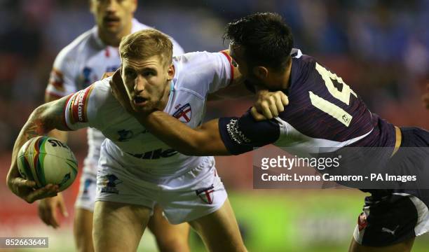 England's Sam Tomkins and France's Eloi Pelissier during the World Cup Quarter Final at the DW Stadium, Wigan.