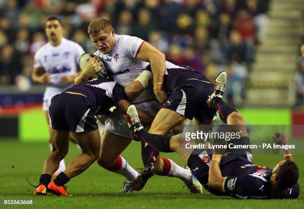 England's George Burgess and France's Eloi Pelissier , Olivier Elima and Jean-Philippe Baile during the World Cup Quarter Final at the DW Stadium,...