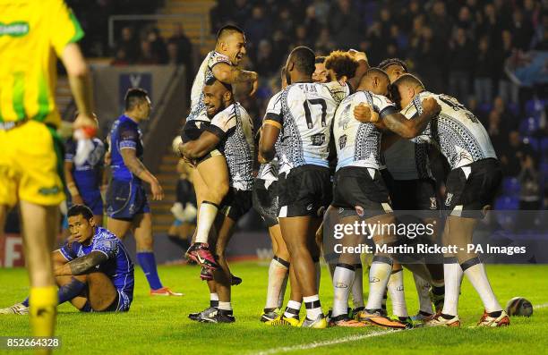 Fiji's Vitale Junior Roqica celebrates his try against Samoa with team mates, during the World Cup Quarter Final at the Halliwell Jones Stadium,...