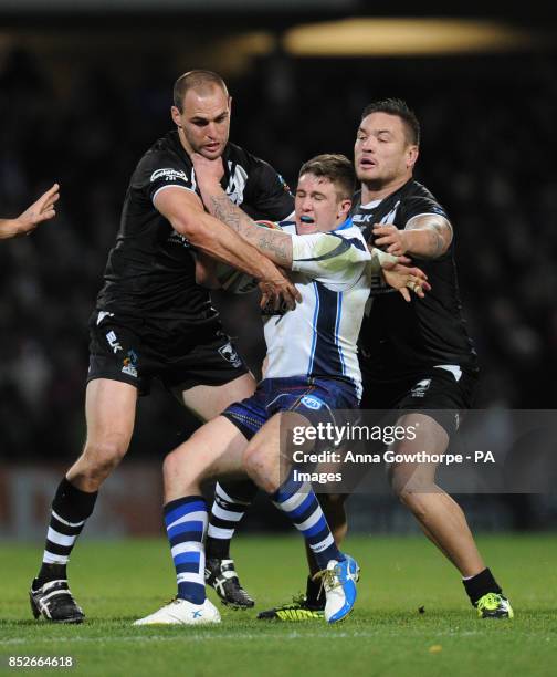 Scotland's Ben Hellewell is tackled by New Zealand's Simon Mannering and Jared Waerea-Hargreaves during the World Cup Quarter Final match at...