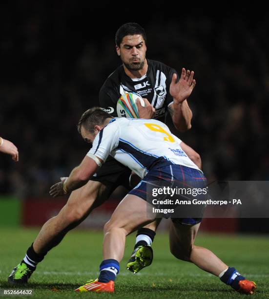 New Zealand's Jesse Bromwich is tackled by Scotland's Ian Henderson during the World Cup Quarter Final match at Headingley Stadium, Leeds.
