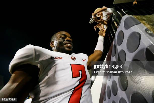 Defensive Back Joe Brown of the Western Kentucky Hilltoppers gives a high five to a young fan after winning 33-21 over Ball States on September 23,...